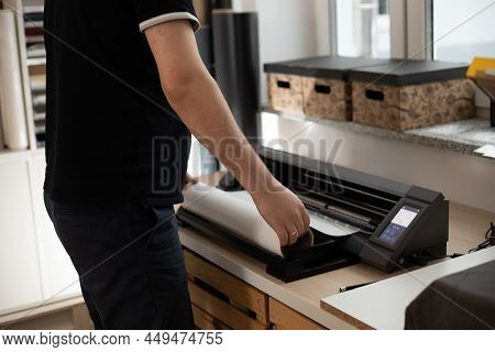 Cropped Man Worker Side Back Using Cutting Carve Application Vinyl Film Membrane Sticker. Printing A