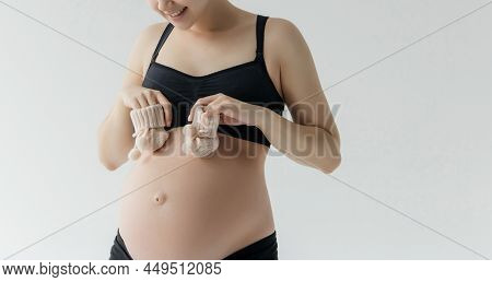 Pregnant Woman Holding Baby Cloth For Baby Newborn Isolated On White Background.pregnant Woman Packi