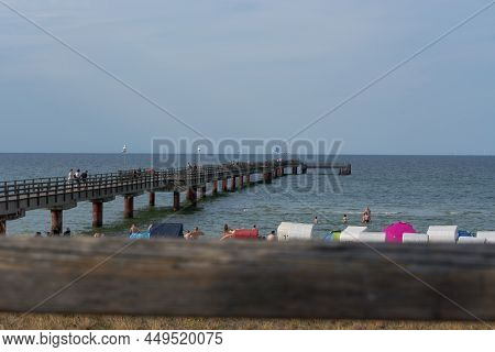 Ostseebad Prerow,  Germany - July 31, 2018: 
Fishermen And Tourists On The Wooden Pier Of The Prerow