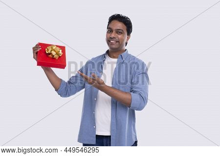 Indian Man Showing Present Over Exceded. Man Holding Gift. Surprise. Gift Box. Very Happy Man Isolat