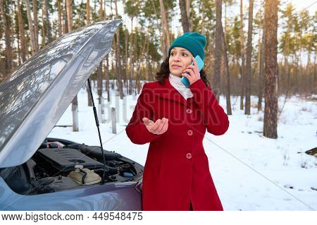 Stunned Middle Age Caucasian Woman Trying To Fix Car Breakdown Or Engine Failure And Waiting For Tow