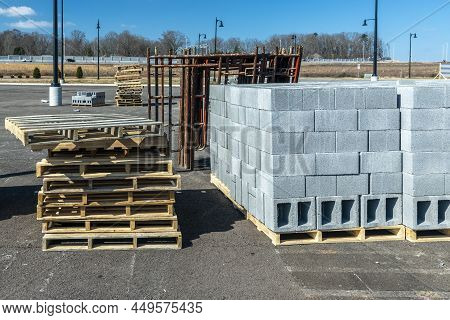 Horizontal Shot Of New Cinderblocks Stacked On Wooden Pallets At A Large Industrial Construction Sit