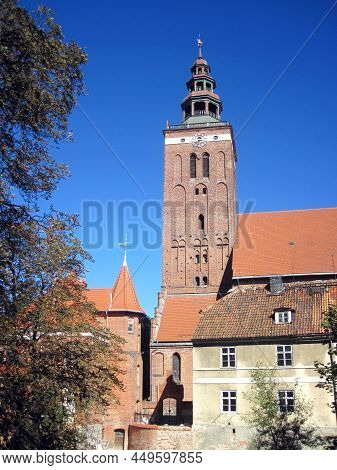 Beautiful View Of A Medieval Brick Clock Tower With A Tiled Roof In An Old Polish Town In The Warmia