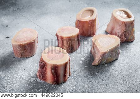Raw Calf Marrow Bones On Butcher Table. Gray Background. Top View
