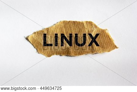 Linux. Text On Brown Torn Paper Isolated On White Background.