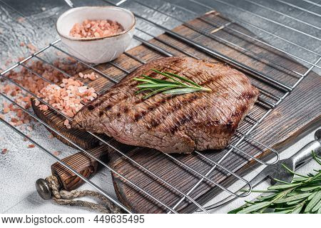 Flank Steak Bbq On A Grill With Rosemary. White Background. Top View