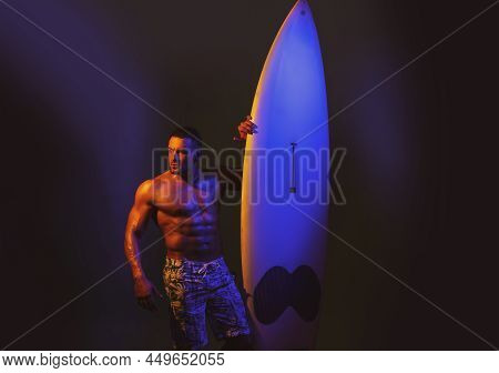 Serfer Bodybuilder Holding Serf Board. Hobby Concept. Male Athlete With Surfboard. Muscular Body Tor