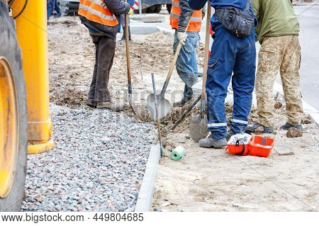The Construction Of A New Pavement By A Group Of Builders Who Are Preparing The Foundation And Plann