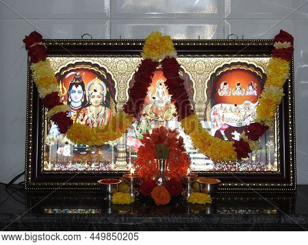 Closeup Of Beautiful Interior Decoration Of Puja Room With Flowers, Antique Diya, Fruits And Technol