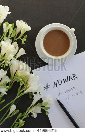 No War Message On White Paper, Cup Of Coffee And White Flowers On Dark Background. Copy Space