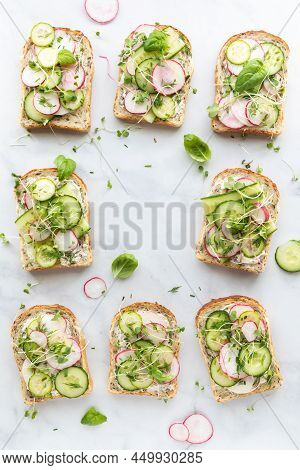 Top Down View Of Cucumber Radish Tartines With Copy Space In The Middle.