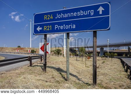 Road Signs Indicating The Direction Of Travel To Pretoria And Johannesburg At The Fork In The Road. 