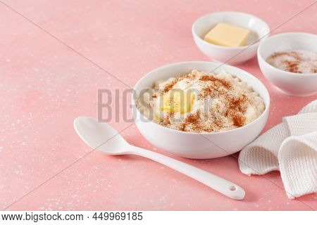 rice pudding with butter cinnamon. french riz au lait, norwegian risgrot, traditional breakfast dessert