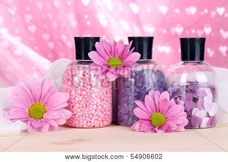 Aromatherapy minerals - colorful bath salt on pink background