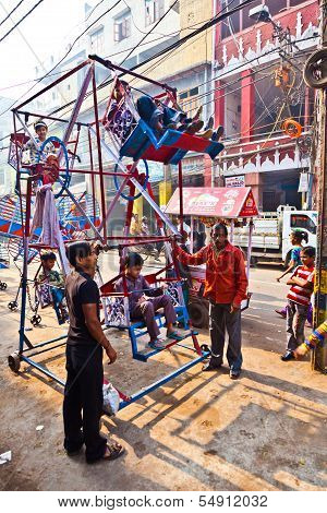 Children Have Fun In A Hand Driven Wheel