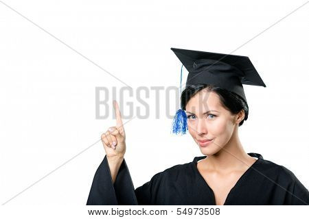 Graduating student in black academic gown and cap making the attention gesture, isolated on white