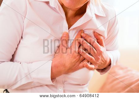 Old woman holding breast because of heart infarction 