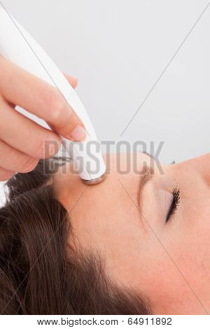 Woman Under Going Microdermabrasion Treatment