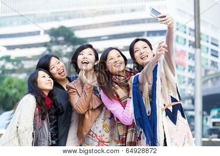 Young female friend taking selfie in Hong Kong