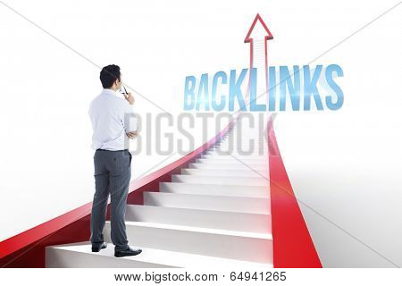 The word backlinks and businessman holding glasses against red arrow with steps graphic