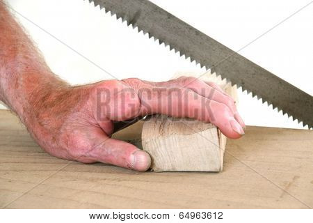 Joiner without one finger sawing a piece of wood