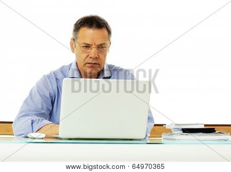 Portrait of a middle aged caucasian man looking at his laptop computer.