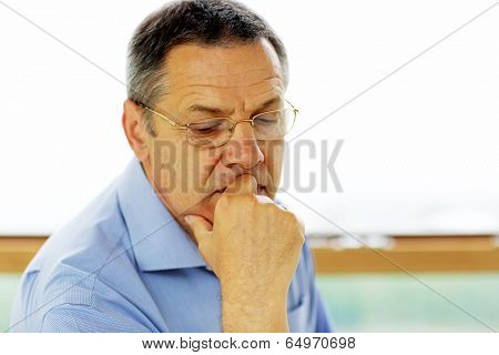 Senior man in glasses looking at camera