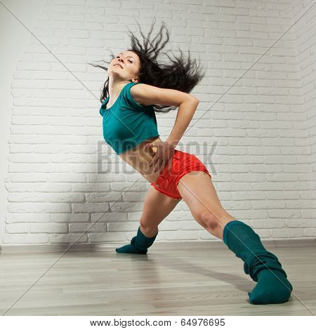 Professional dancer in studio on grey background