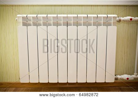 Hot white battery on the wall in the room
