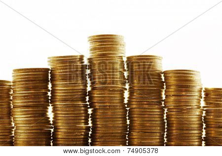 Seven piles of gold coins on a white background