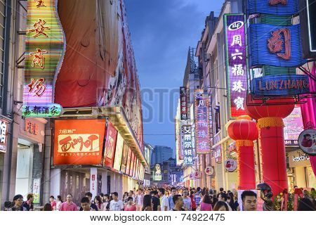 GUANGZHOU, CHINA - MAY 25, 2014: Pedestrians pass through Shangxiajiu Pedestrian Street. The street is the main shopping district of the city and a major tourist attraction.