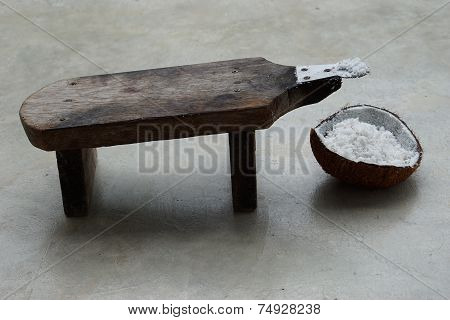 half of coconut shell with coconut grater 3