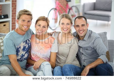 Roommates sitting together in couch