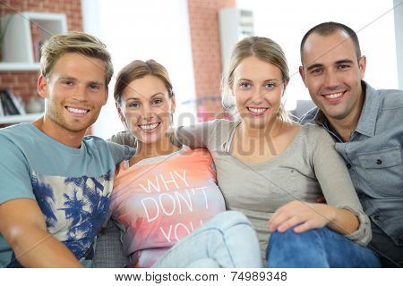 Roommates sitting together in couch 