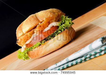 Tasty fish burger in corn bun