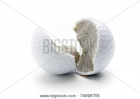 Broken golf ball on white isolated background