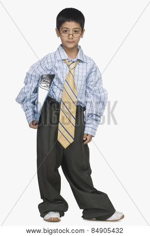 Portrait of a boy wearing oversized clothes and holding a file