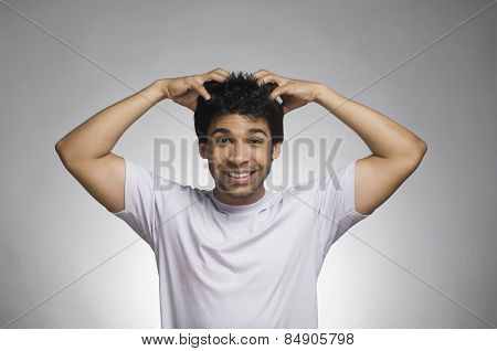 Man making a face with his hands in hair