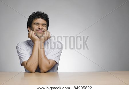 Man leaning on elbows and making a face