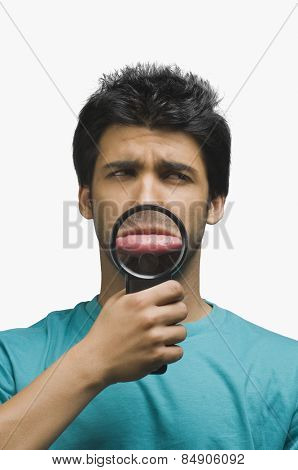 Man making a funny face in front of a magnifying glass