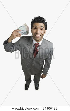 Businessman holding money and smiling