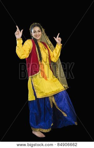 Woman in traditional Punjabi dress dancing