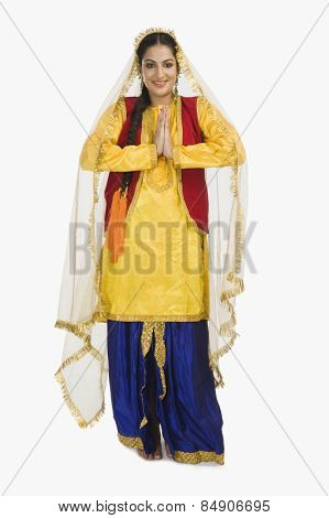Woman in traditional Punjabi dress greeting