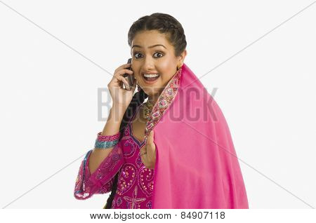 Woman wearing a salwar kameez and talking on a mobile phone