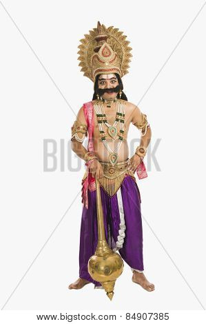 Portrait of a man dressed-up as Ravana the Hindu mythological character and holding a mace