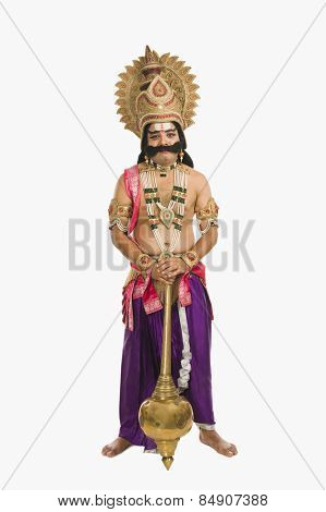 Portrait of a man dressed-up as Ravana the Hindu mythological character and holding a mace