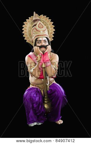 Stage artist dressed-up as Ravana and making a sad face
