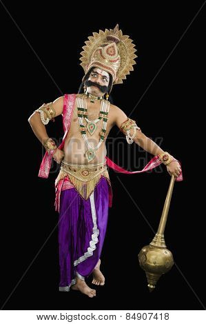 Traditional stage artist dressed-up as Ravana and thinking