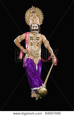 Portrait of a man dressed-up as Ravana the Hindu mythological character and holding a mace