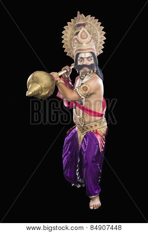 Portrait of a stage artist dressed-up as Ravana the Hindu mythological character and holding a mace